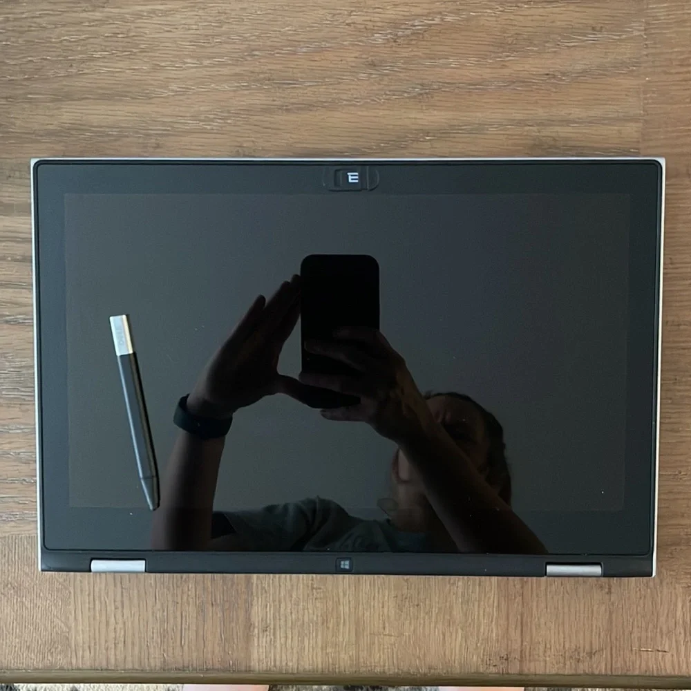 Silver Dell laptop that folds over to a tablet